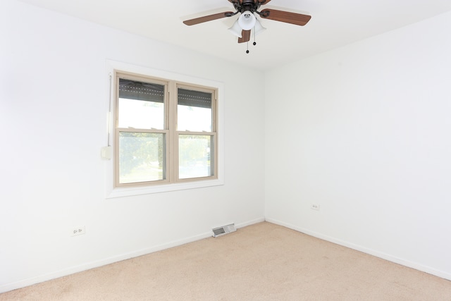 spare room with light carpet and ceiling fan