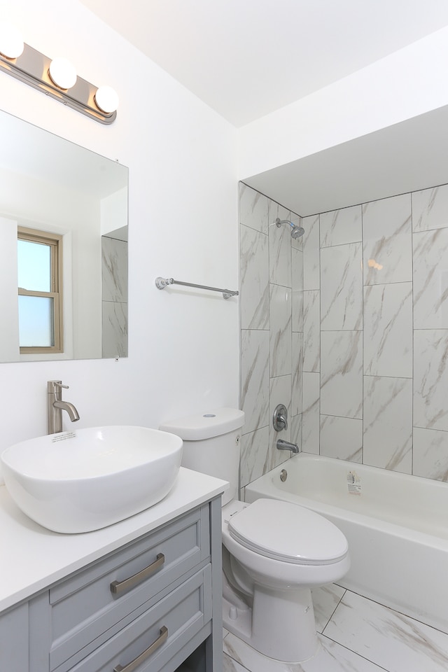 full bathroom with vanity, toilet, and tiled shower / bath