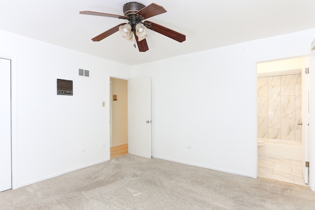 carpeted spare room with ceiling fan