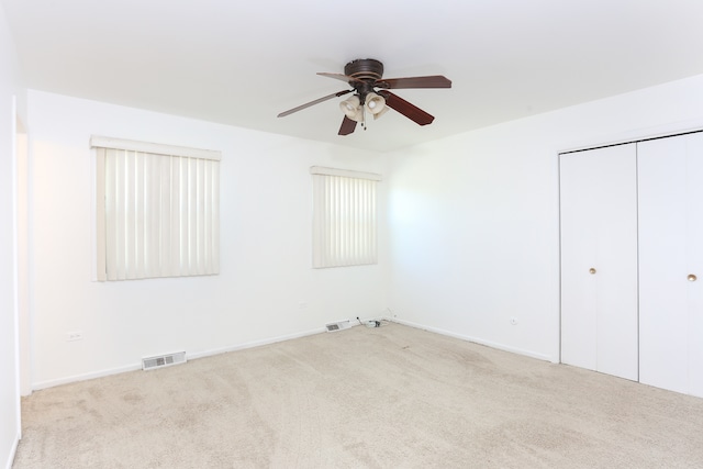 empty room featuring light carpet and ceiling fan