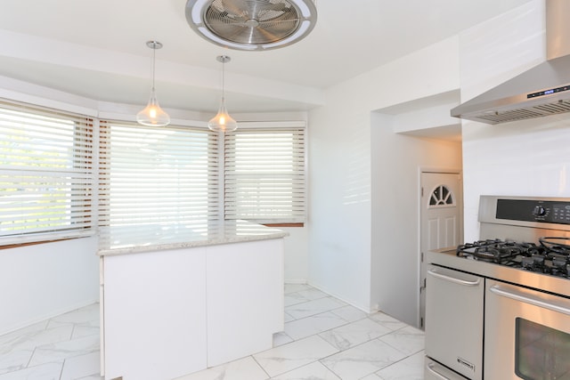 kitchen with a healthy amount of sunlight, wall chimney range hood, hanging light fixtures, white cabinetry, and gas range