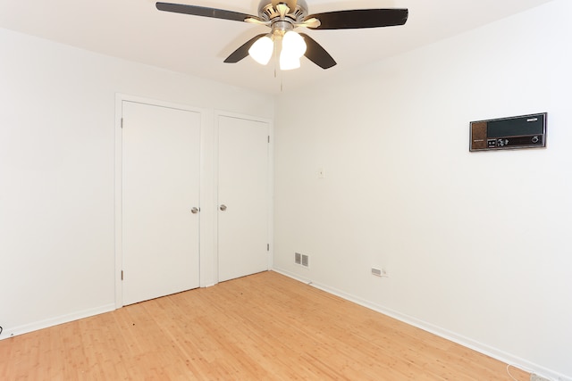 unfurnished bedroom featuring ceiling fan and hardwood / wood-style flooring