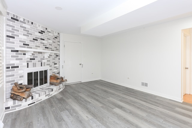 unfurnished living room with a fireplace and hardwood / wood-style floors