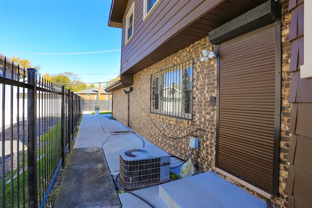 view of side of property with a patio and central AC unit