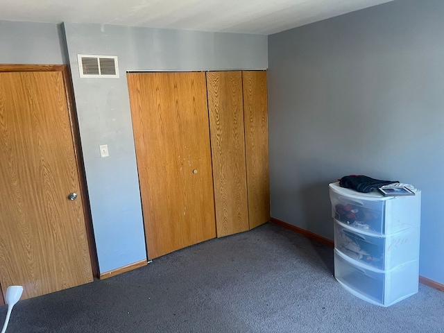 unfurnished bedroom featuring carpet floors and a closet