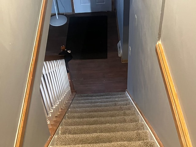 staircase featuring hardwood / wood-style flooring