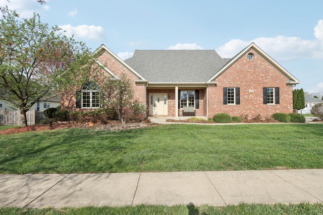 140 E Lynn St, South Elgin, IL 60177 - view of front of house featuring a front yard, a shingled roof, and brick siding