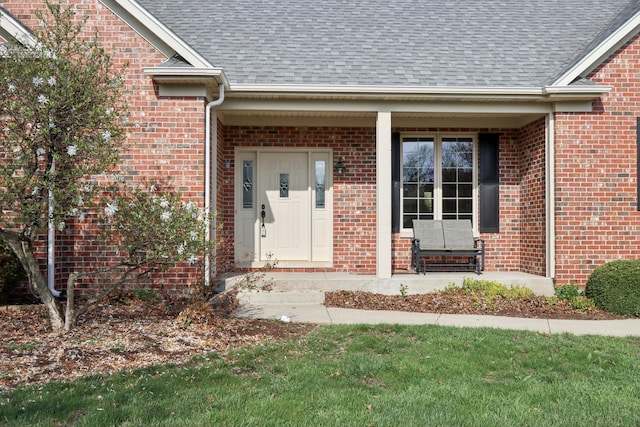 140 E Lynn St, South Elgin, IL 60177 - property entrance featuring covered porch, a shingled roof, and brick siding
