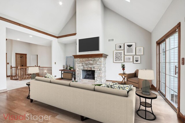 140 E Lynn St, South Elgin, IL 60177 - living room with a fireplace, light wood finished floors, visible vents, and high vaulted ceiling