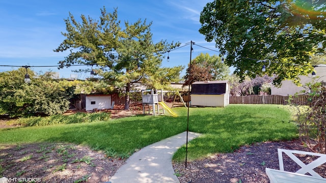 view of yard with a playground and a shed