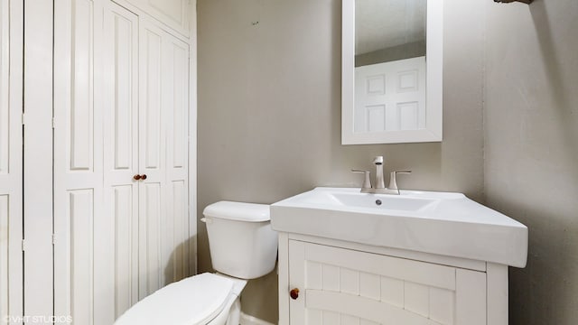 bathroom with toilet and vanity