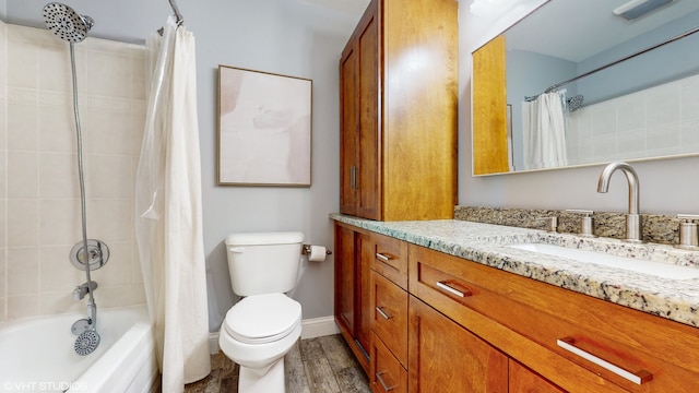 full bathroom featuring vanity, toilet, hardwood / wood-style flooring, and shower / tub combo