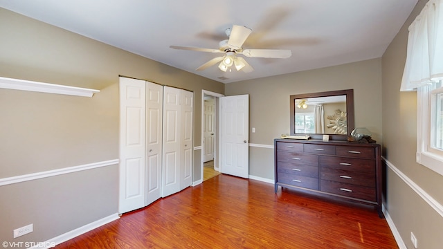 unfurnished bedroom with a closet, ceiling fan, and dark hardwood / wood-style flooring