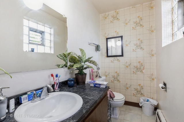 bathroom featuring baseboard heating, tile patterned flooring, vanity, and toilet