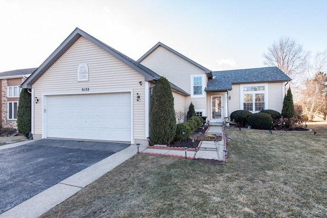 ranch-style house with a garage and a front lawn