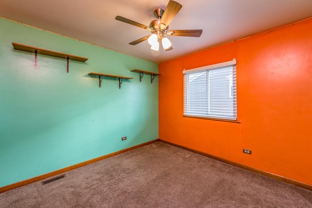 empty room featuring carpet flooring and ceiling fan