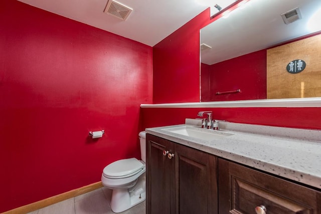 bathroom featuring tile patterned flooring, vanity, and toilet