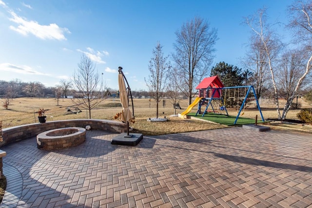 view of patio / terrace featuring a playground and a fire pit