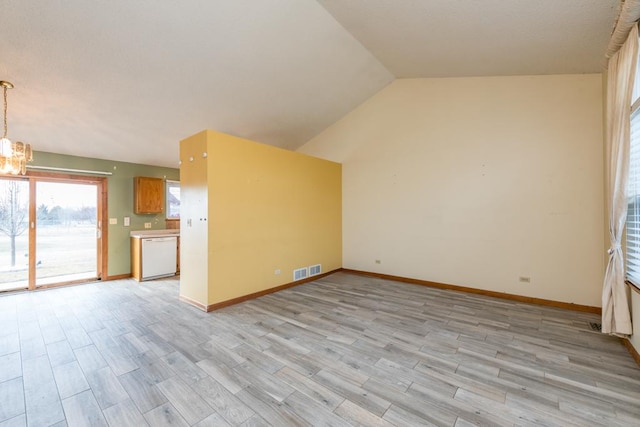 unfurnished living room featuring a chandelier, light hardwood / wood-style flooring, and vaulted ceiling