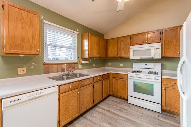 kitchen with white appliances, light hardwood / wood-style flooring, lofted ceiling, and sink