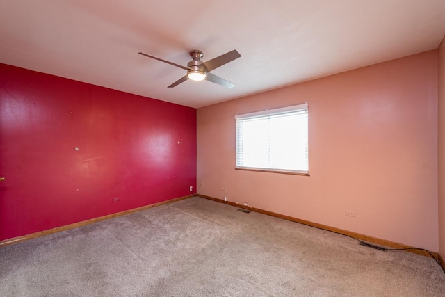 unfurnished room featuring carpet and ceiling fan