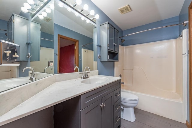 full bathroom featuring tile patterned flooring, shower / washtub combination, vanity, and toilet