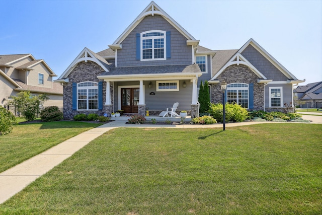 craftsman-style house with a front yard and a porch