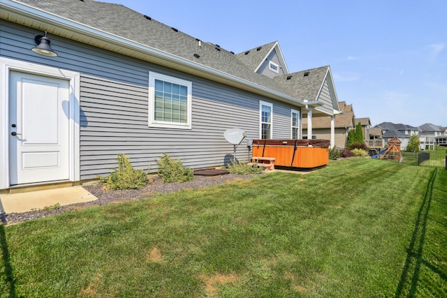 exterior space with a lawn and a hot tub