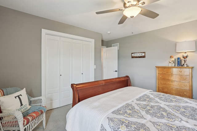 bedroom featuring a closet, light colored carpet, and ceiling fan