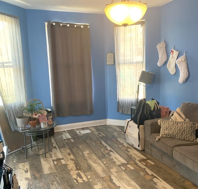 interior space featuring visible vents, baseboards, and wood finished floors