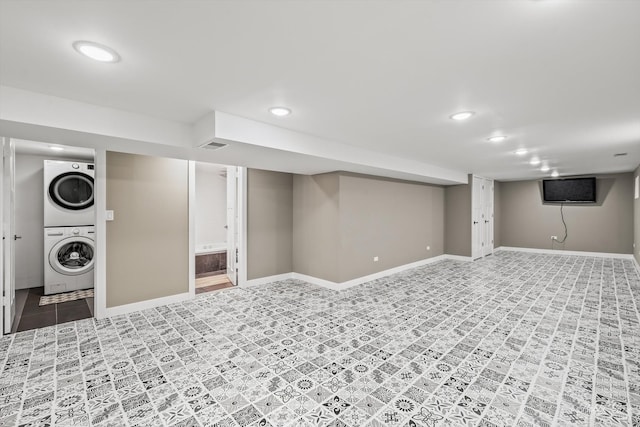 basement featuring stacked washer / dryer