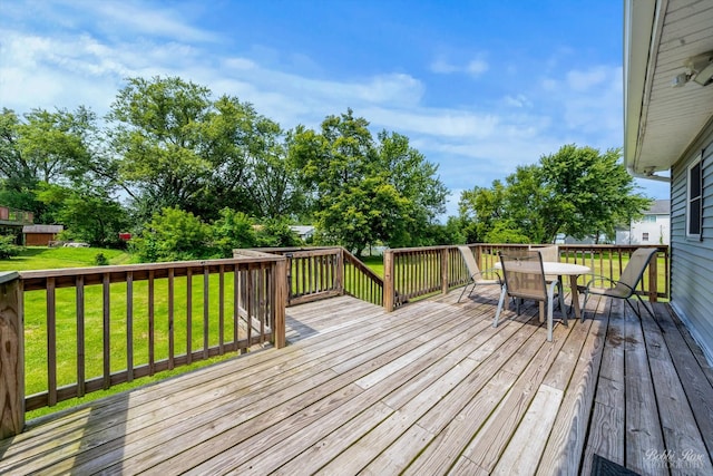 wooden terrace featuring a yard