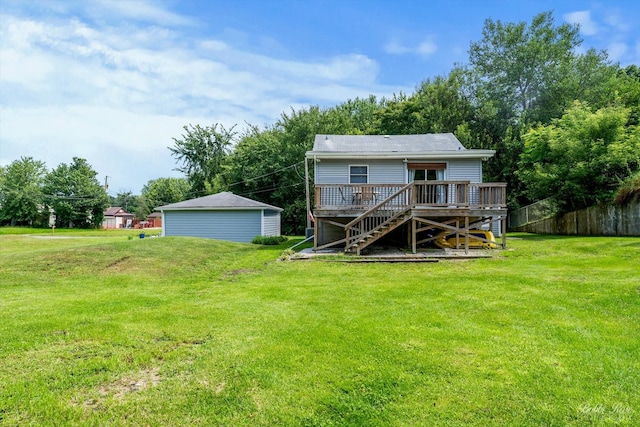 rear view of property with a yard and a deck