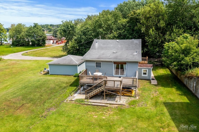 back of property with a lawn and a deck