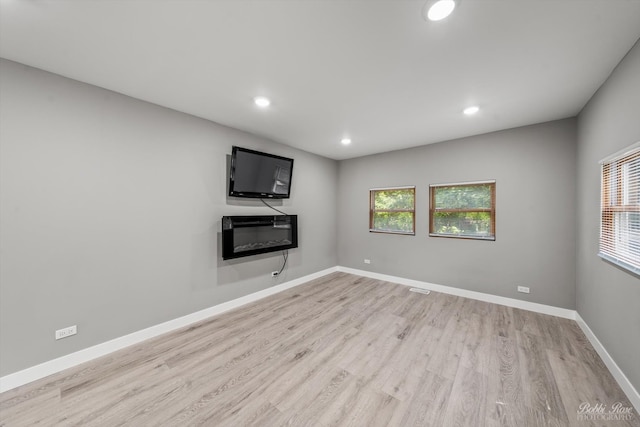 unfurnished living room with light hardwood / wood-style floors