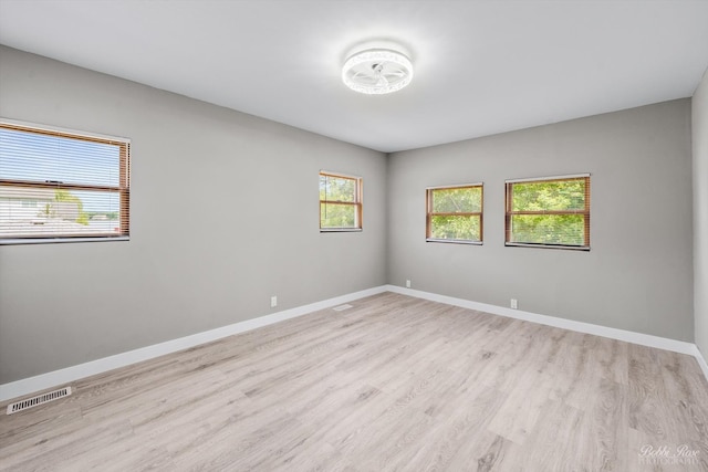 unfurnished room with light hardwood / wood-style flooring