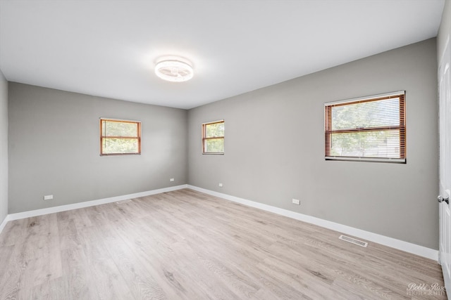 unfurnished room featuring light hardwood / wood-style floors