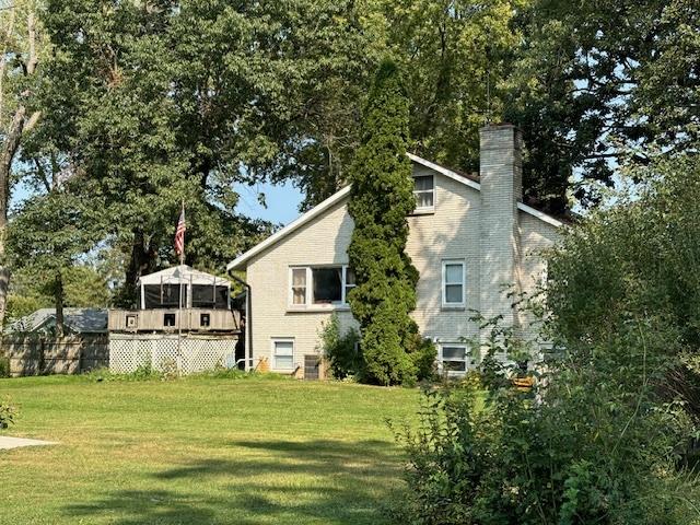 rear view of house with a yard