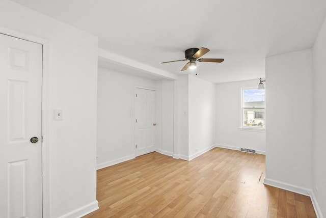 spare room featuring light hardwood / wood-style flooring and ceiling fan