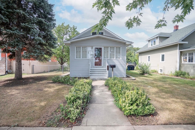 bungalow-style house featuring a front lawn