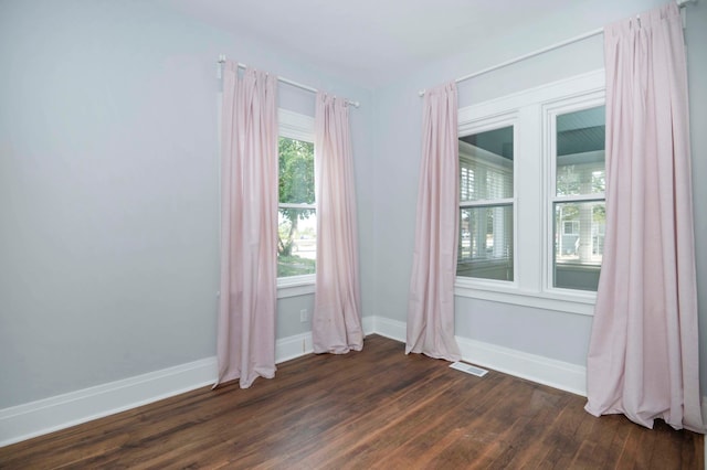 empty room with dark wood-type flooring