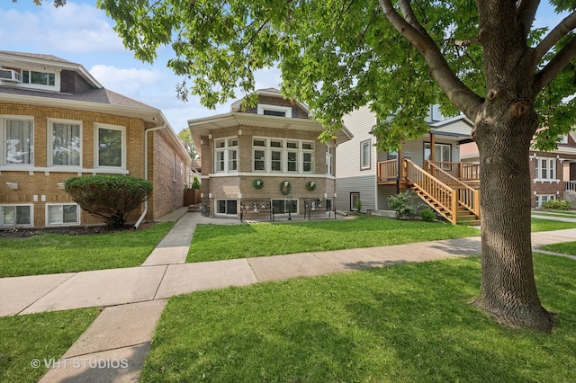 view of front of house with a patio and a front lawn