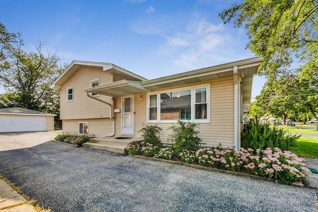 split level home with a garage and an outbuilding