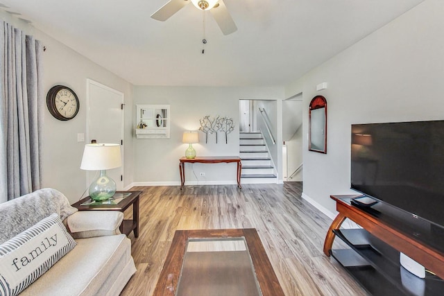 living room with hardwood / wood-style floors and ceiling fan