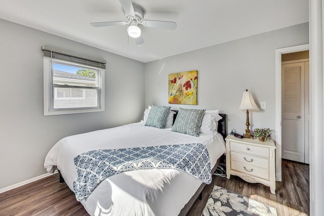 bedroom with dark wood-type flooring and ceiling fan