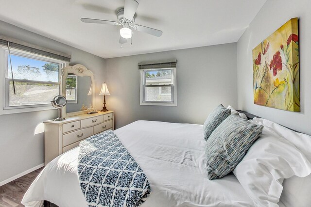 bedroom with ceiling fan and wood-type flooring