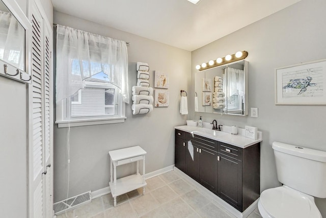 bathroom featuring vanity, toilet, and tile patterned floors