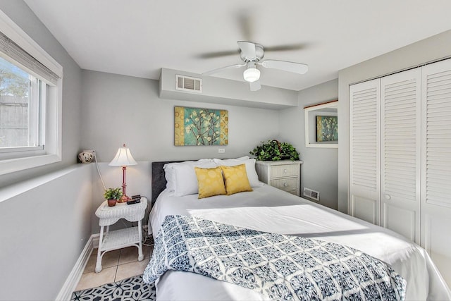 bedroom featuring a closet, ceiling fan, and light tile patterned flooring