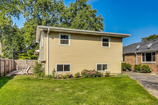 view of side of property with a lawn