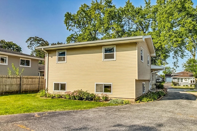 view of property exterior featuring a lawn